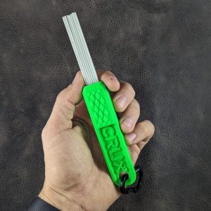 Green mini CRUX Original Gold Brush with long white bristles for gold prospecting bedrock cleaning.