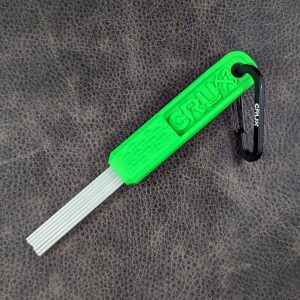 Green mini CRUX Original Gold Brush with long white bristles for gold prospecting bedrock cleaning.