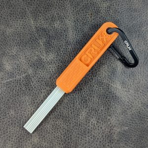 Orange mini CRUX Original Gold Brush with long white bristles for gold prospecting bedrock cleaning.
