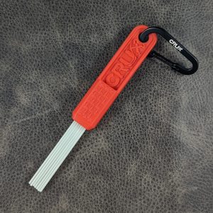 Red mini CRUX Original Gold Brush with long white bristles for gold prospecting bedrock cleaning.
