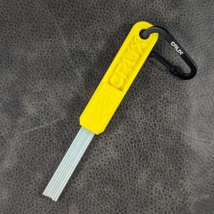 Yellow mini CRUX Original Gold Brush with long white bristles for gold prospecting bedrock cleaning.